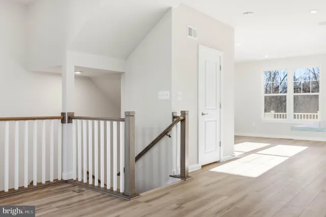 a view of a kitchen with kitchen island a sink and a large window