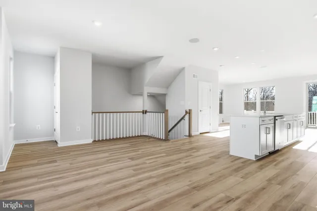a view of a room with wooden floor and window