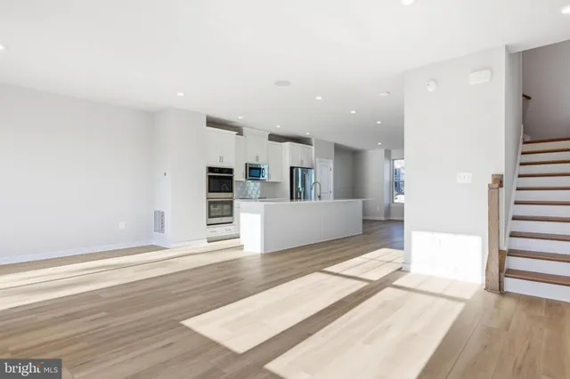 an empty room with closet and fan