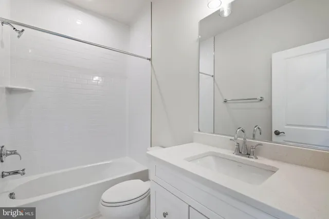 a bathroom with double sink and a mirror