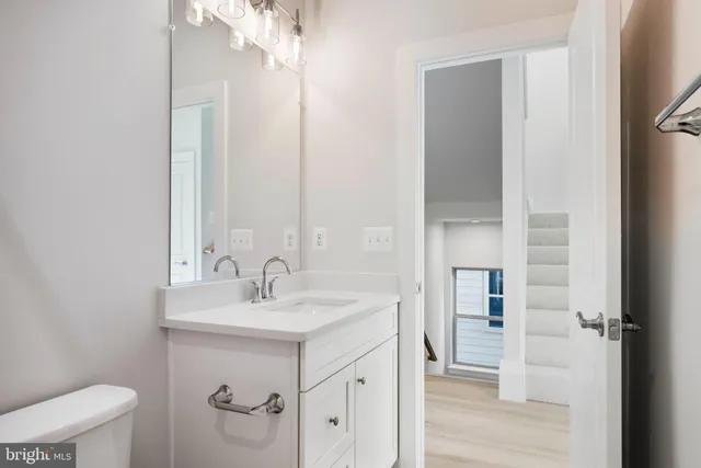 a white toilet sitting next to a shower