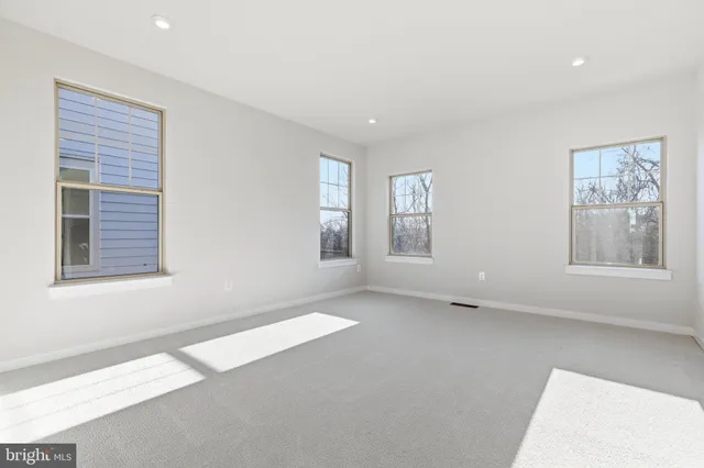 a view of staircase with white walls and railing