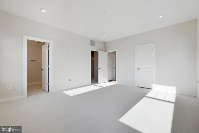 a large white bed in a white room