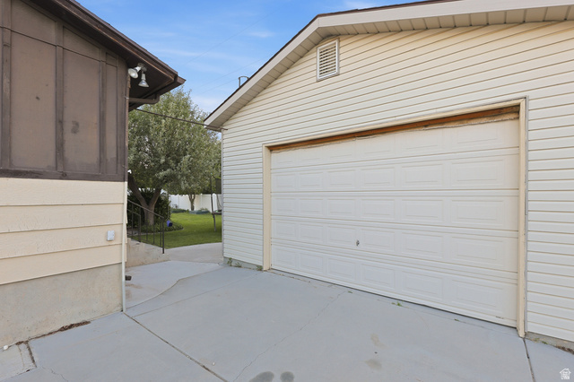 822 Pinewood Circle Price, UT 84501 - Photo 41 of 49 Detached garage featuring white paneling, a vented gable, and concrete driveway