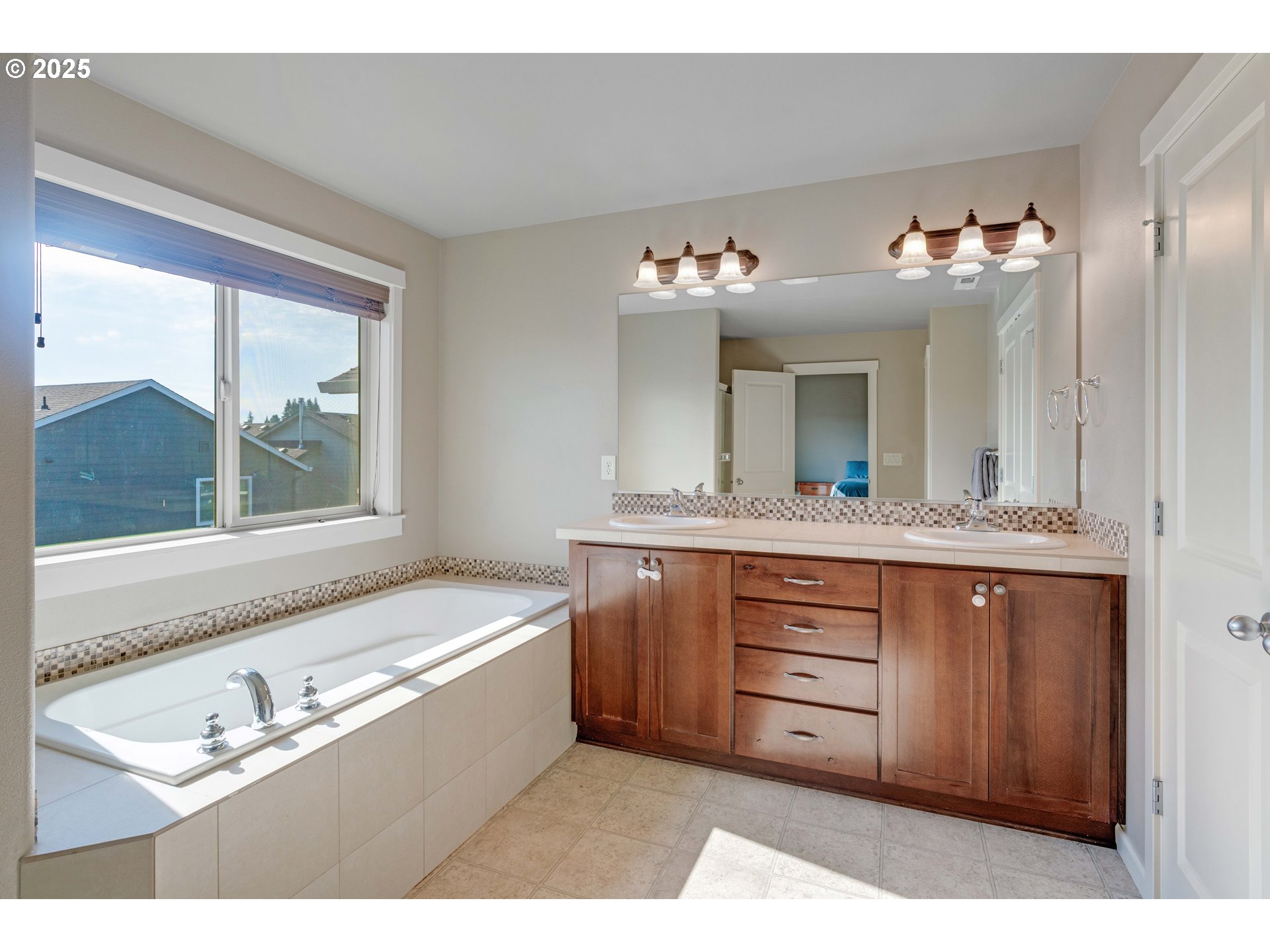 514 North 40th Avenue Ridgefield, WA 98642 - Photo 29 of 46 a bathroom with a sink vanity and a mirror
