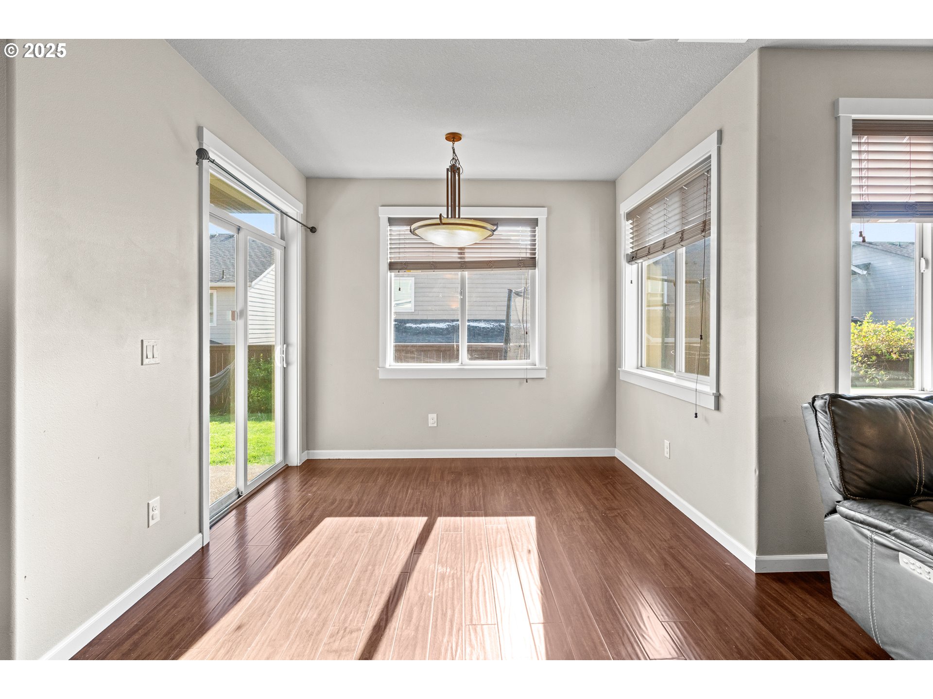 514 North 40th Avenue Ridgefield, WA 98642 - Photo 8 of 46 a view of an empty room with wooden floor and windows