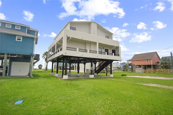 a front view of house with a garden and patio