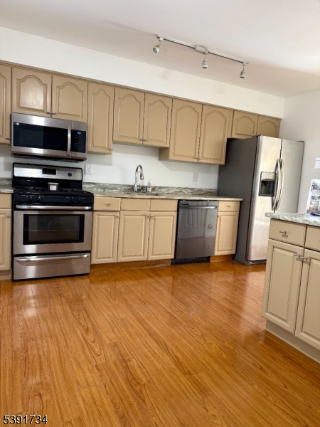 608 Robin Road Hillsborough, NJ 08844 - Photo 6 of 9 a kitchen with granite countertop a refrigerator stove and wooden floor