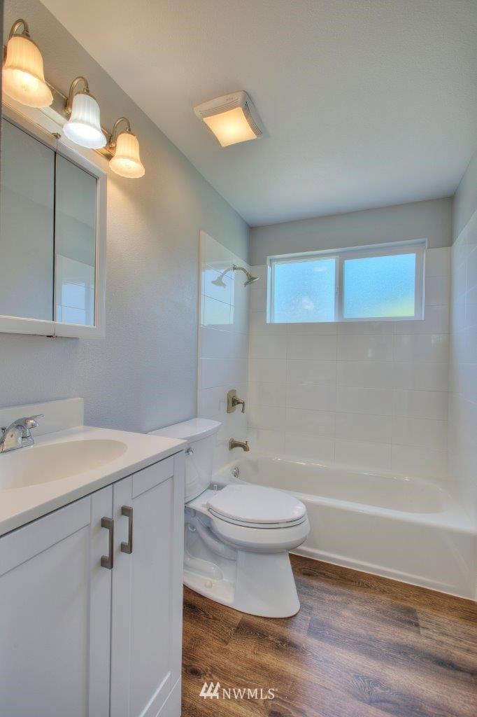 12402 Southeast 160th Street Renton, WA 98058 - Photo 14 of 21 a bathroom with a sink a toilet and shower