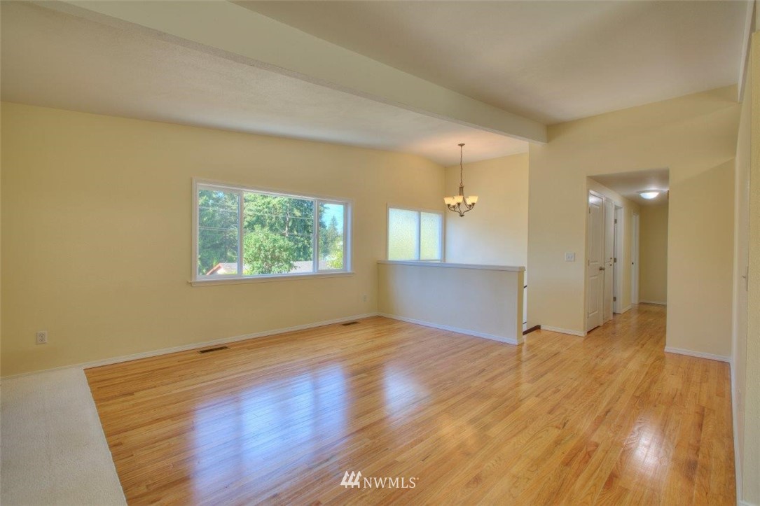 12402 Southeast 160th Street Renton, WA 98058 - Photo 4 of 21 an empty room with wooden floor and windows