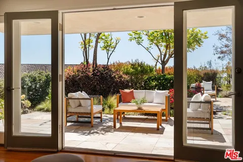a bedroom with a large bed and a large window