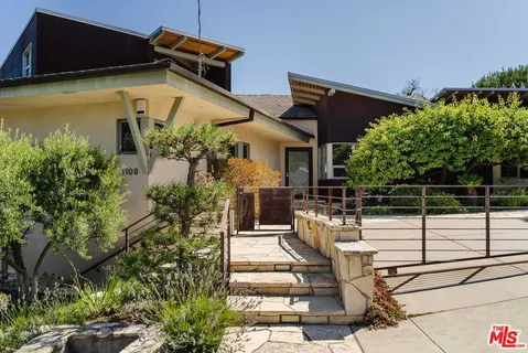 a view of a chairs and table in the patio