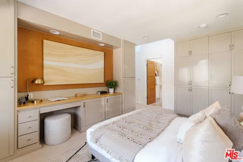 a bathroom with a granite countertop sink a toilet a mirror a bathtub and shower