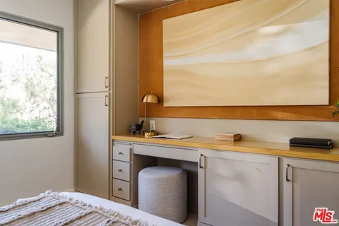 a bedroom with bed and window