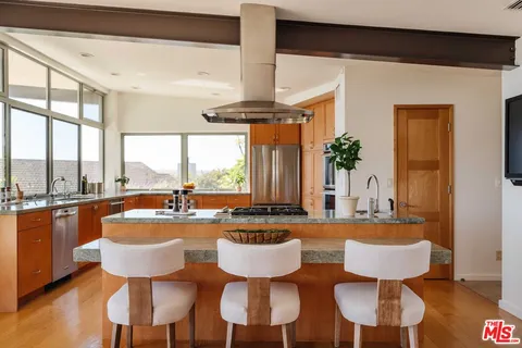 a dining room with furniture a chandelier and wooden floor