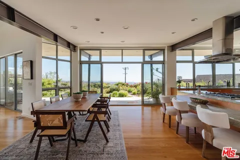 a dining room with furniture window and wooden floor