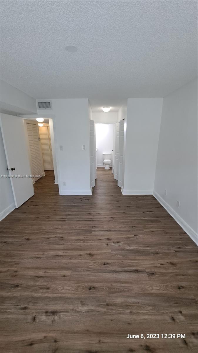 15770 Southwest 106th Terrace, Unit 104 Miami, FL 33196 - Photo 12 of 30 a view of a hallway with wooden floor