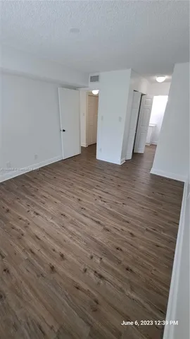a view of a room with wooden floor