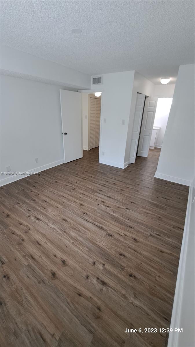 15770 Southwest 106th Terrace, Unit 104 Miami, FL 33196 - Photo 13 of 30 a view of a room with wooden floor
