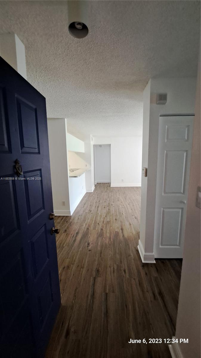 15770 Southwest 106th Terrace, Unit 104 Miami, FL 33196 - Photo 3 of 30 a view of a hardwood floor in an empty room