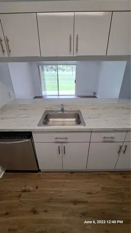 a kitchen with a sink and a window