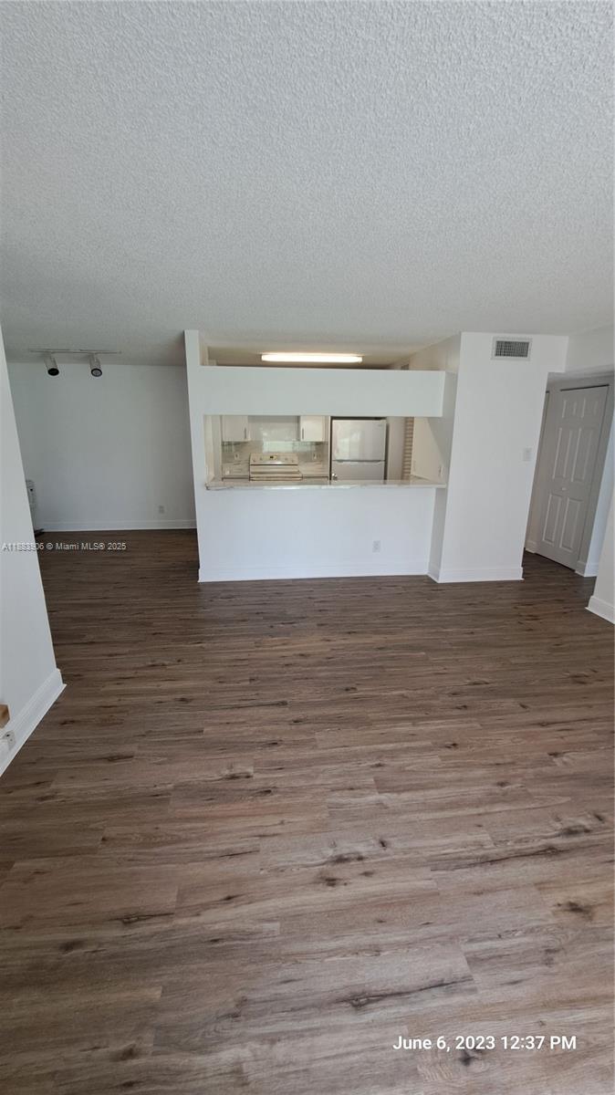15770 Southwest 106th Terrace, Unit 104 Miami, FL 33196 - Photo 10 of 30 a view of empty room with wooden floor
