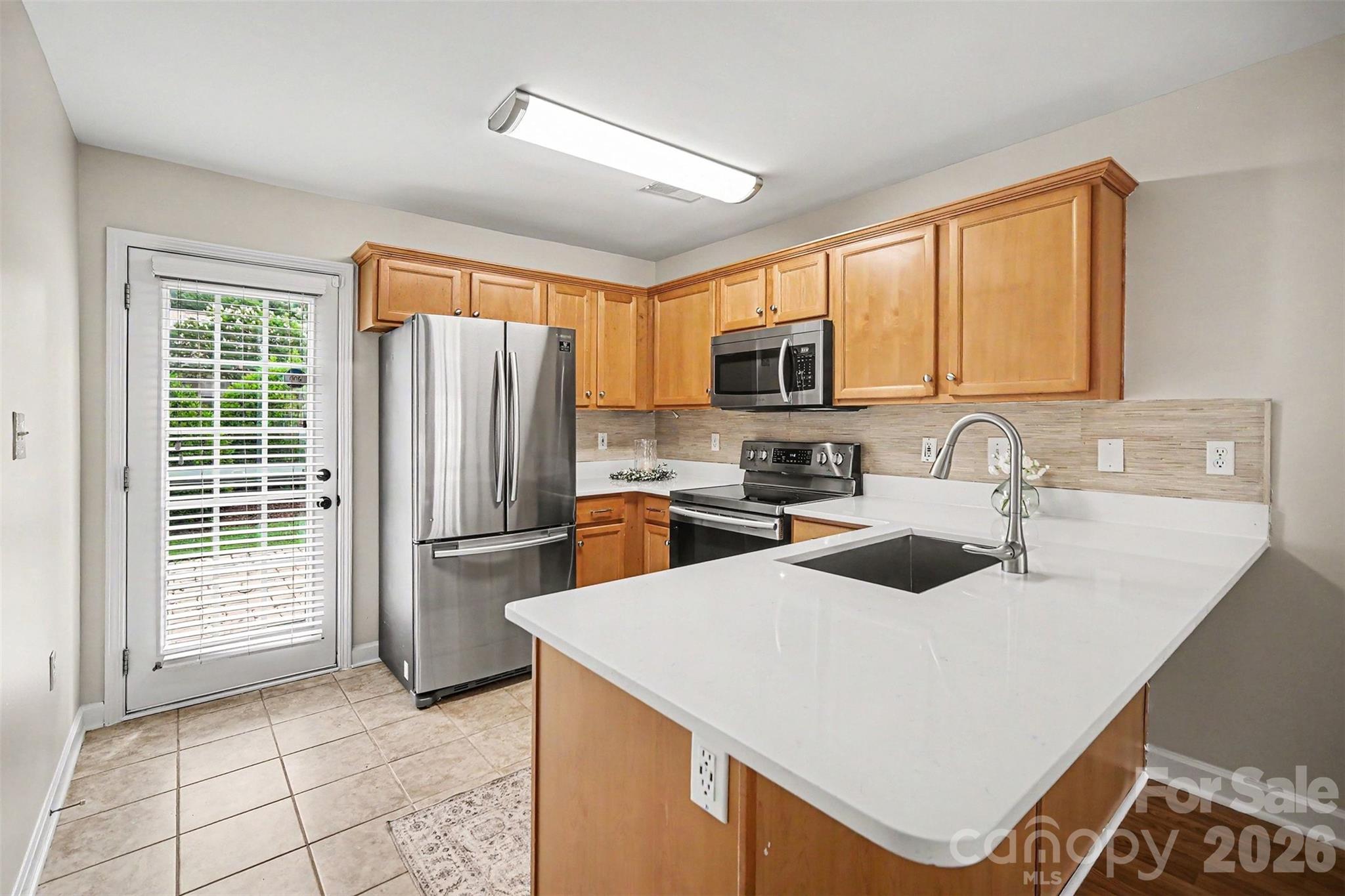 1210 Sheldon Brook Lane Fort Mill, SC 29707 - Photo 3 of 26 a kitchen with kitchen island a counter top space appliances and a sink