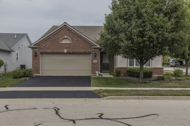 2434 Rolling Ridge Elgin, IL 60124 - Photo 1 of 17 a front view of a house with a yard and garage