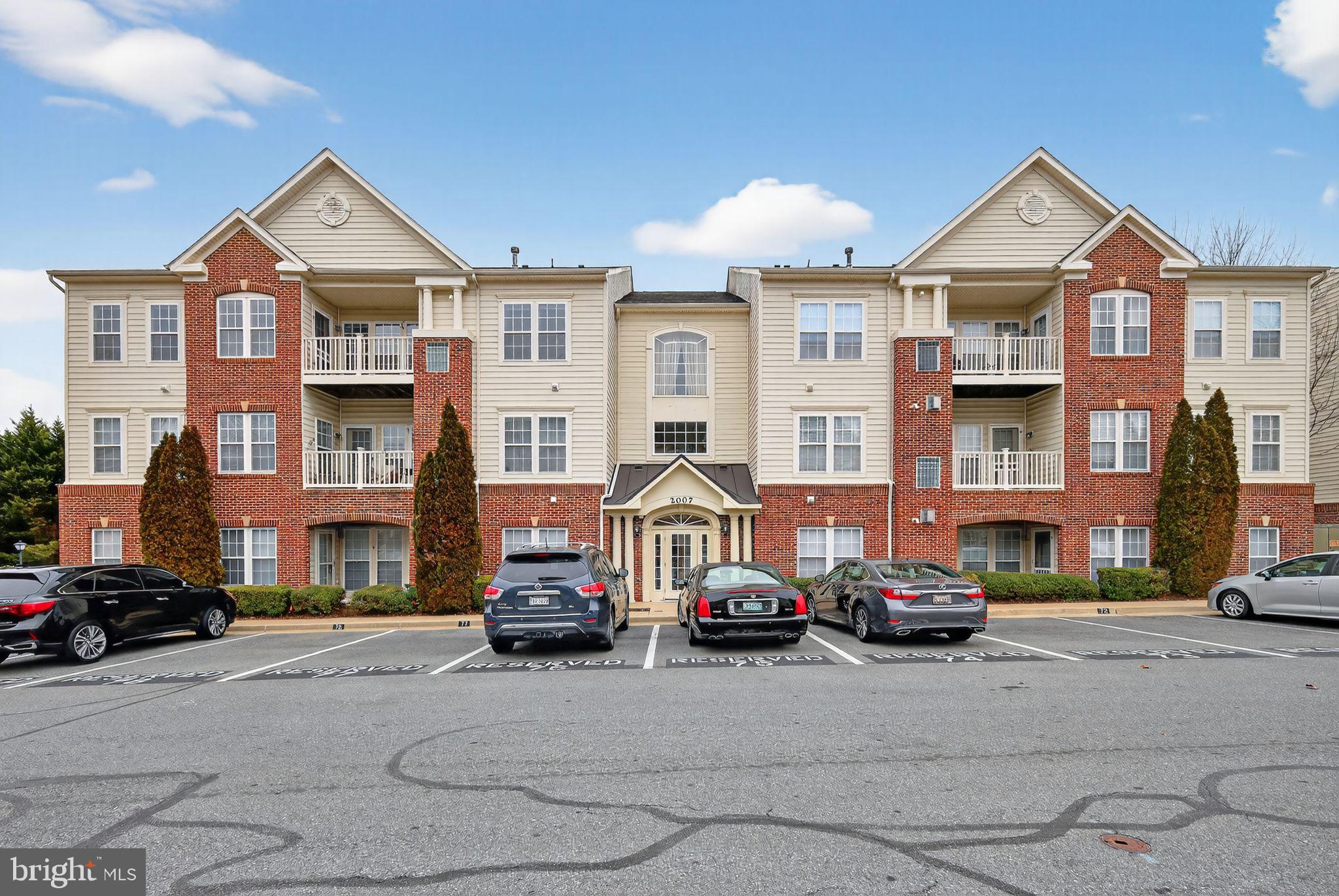 2007 Connor Court, Unit 701J Bowie, MD 20721 - Photo 2 of 15 a front view of a building with cars parked