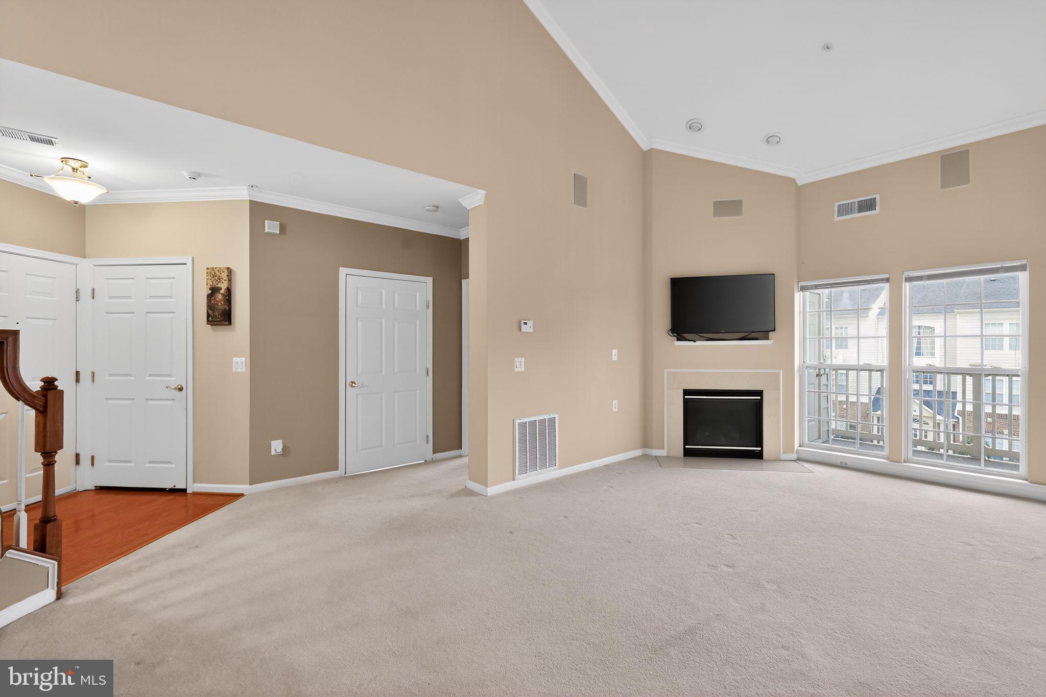 2007 Connor Court, Unit 701J Bowie, MD 20721 - Photo 3 of 15 a view of an empty room with a fireplace and a window