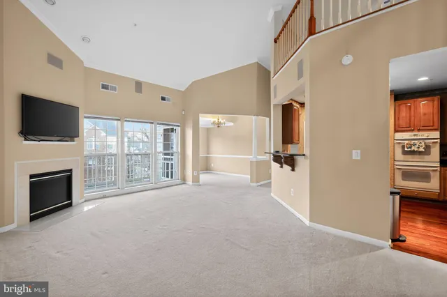 a view of a livingroom with an empty space and a fireplace