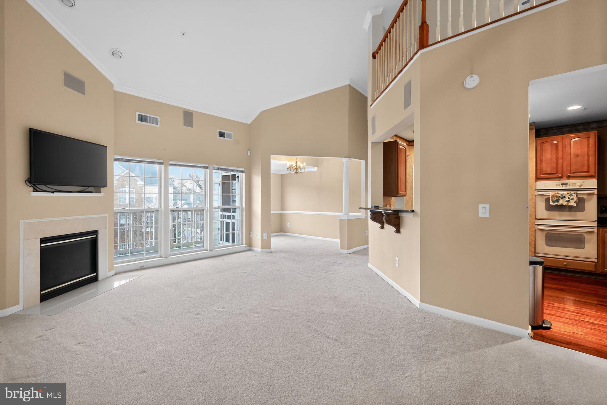 2007 Connor Court, Unit 701J Bowie, MD 20721 - Photo 4 of 15 a view of a livingroom with an empty space and a fireplace