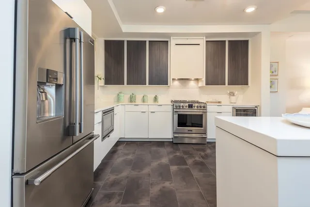 a kitchen with a sink stove and refrigerator