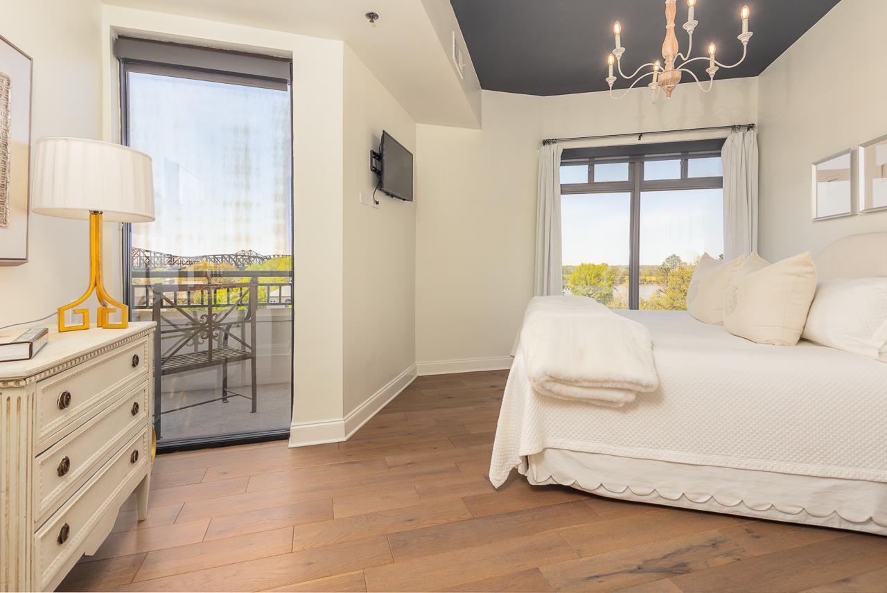 717 Riverside Drive, Unit 506 Memphis, TN 38103 - Photo 11 of 37 a spacious bedroom with a bed and a cabinets
