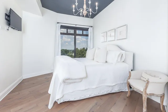 a large white bed in a white room