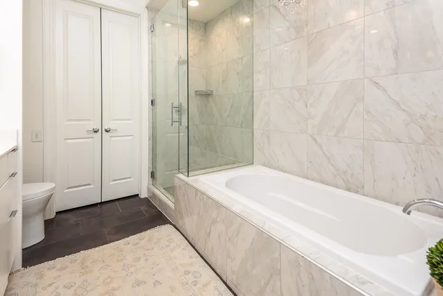 a spacious bathroom with a bathtub and a shower