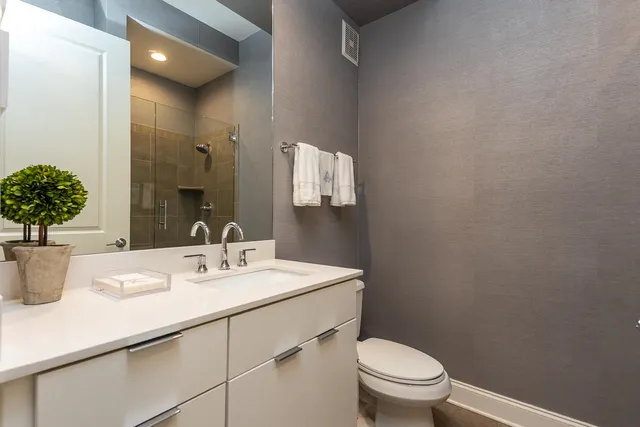 a bathroom with a sink toilet and a mirror