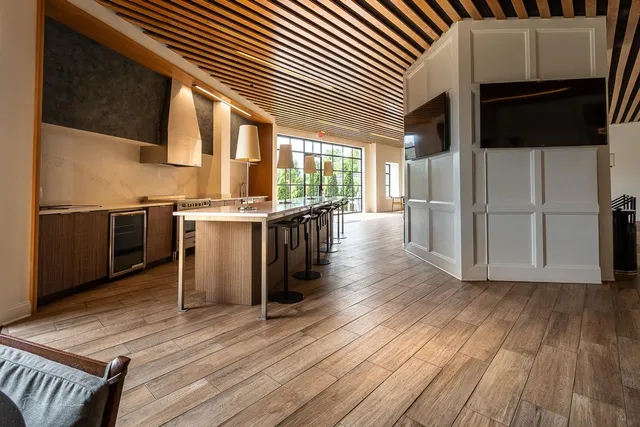 a kitchen with stainless steel appliances granite countertop a stove and a wooden floors