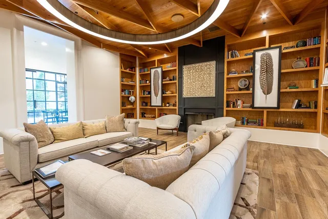 a living room with furniture and large window