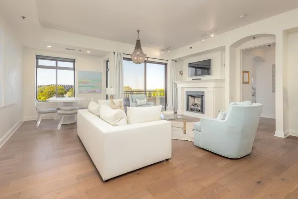 a living room with furniture a fireplace and a flat screen tv