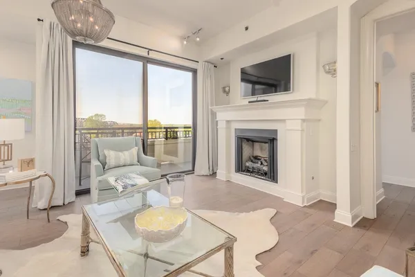 a living room with furniture and large windows
