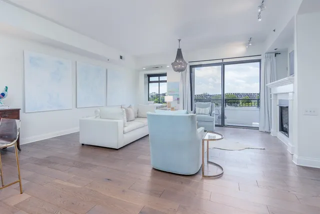 a living room with furniture and large windows