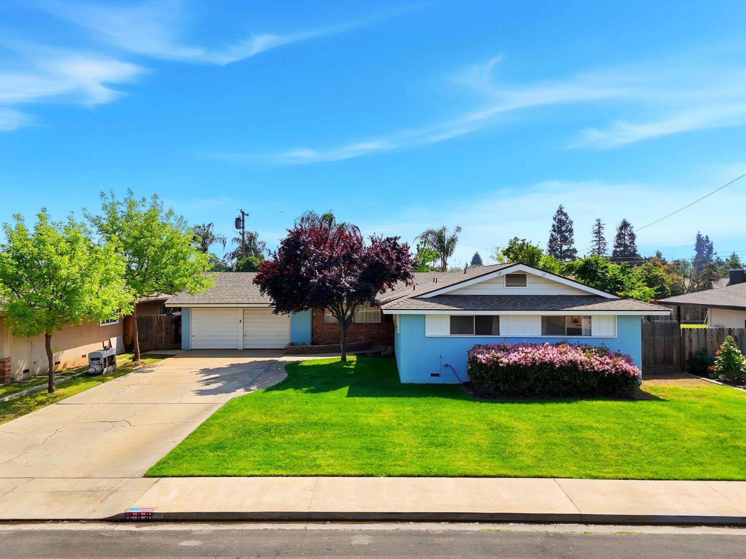 a front view of a house with a garden