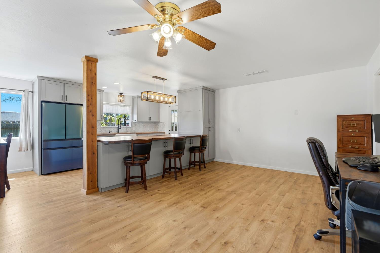 289 West Cypress Avenue Reedley, CA 93654 - Photo 12 of 45 a view of a workspace with furniture and a chandelier