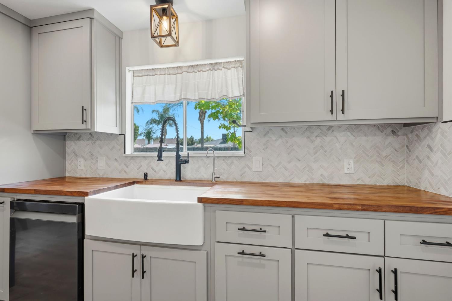289 West Cypress Avenue Reedley, CA 93654 - Photo 16 of 45 a kitchen with a sink and cabinets