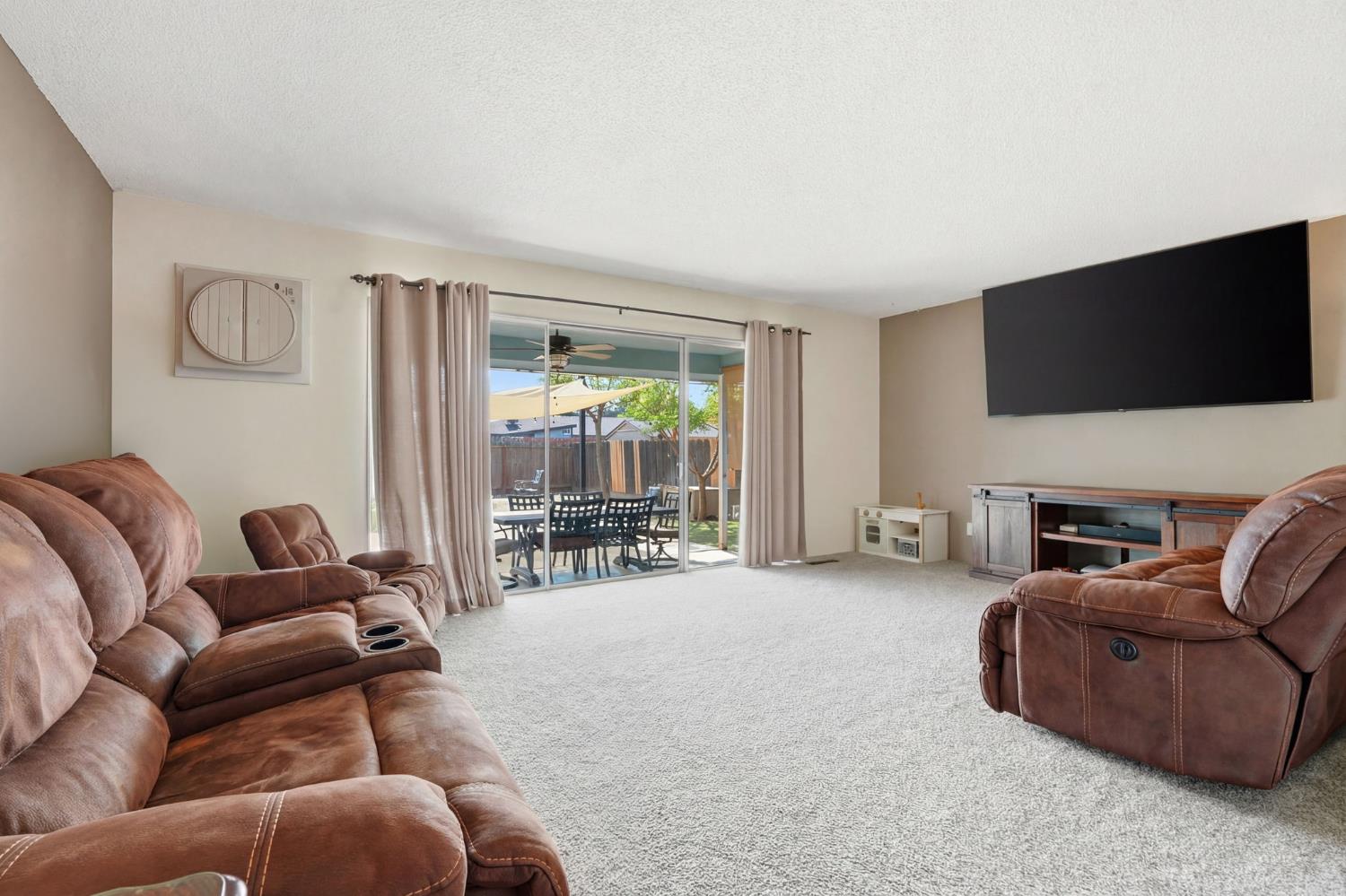 289 West Cypress Avenue Reedley, CA 93654 - Photo 19 of 45 a living room with furniture a flat screen tv and a large window