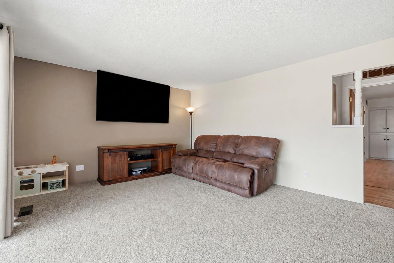 289 West Cypress Avenue Reedley, CA 93654 - Photo 20 of 45 a living room with furniture and a flat screen tv