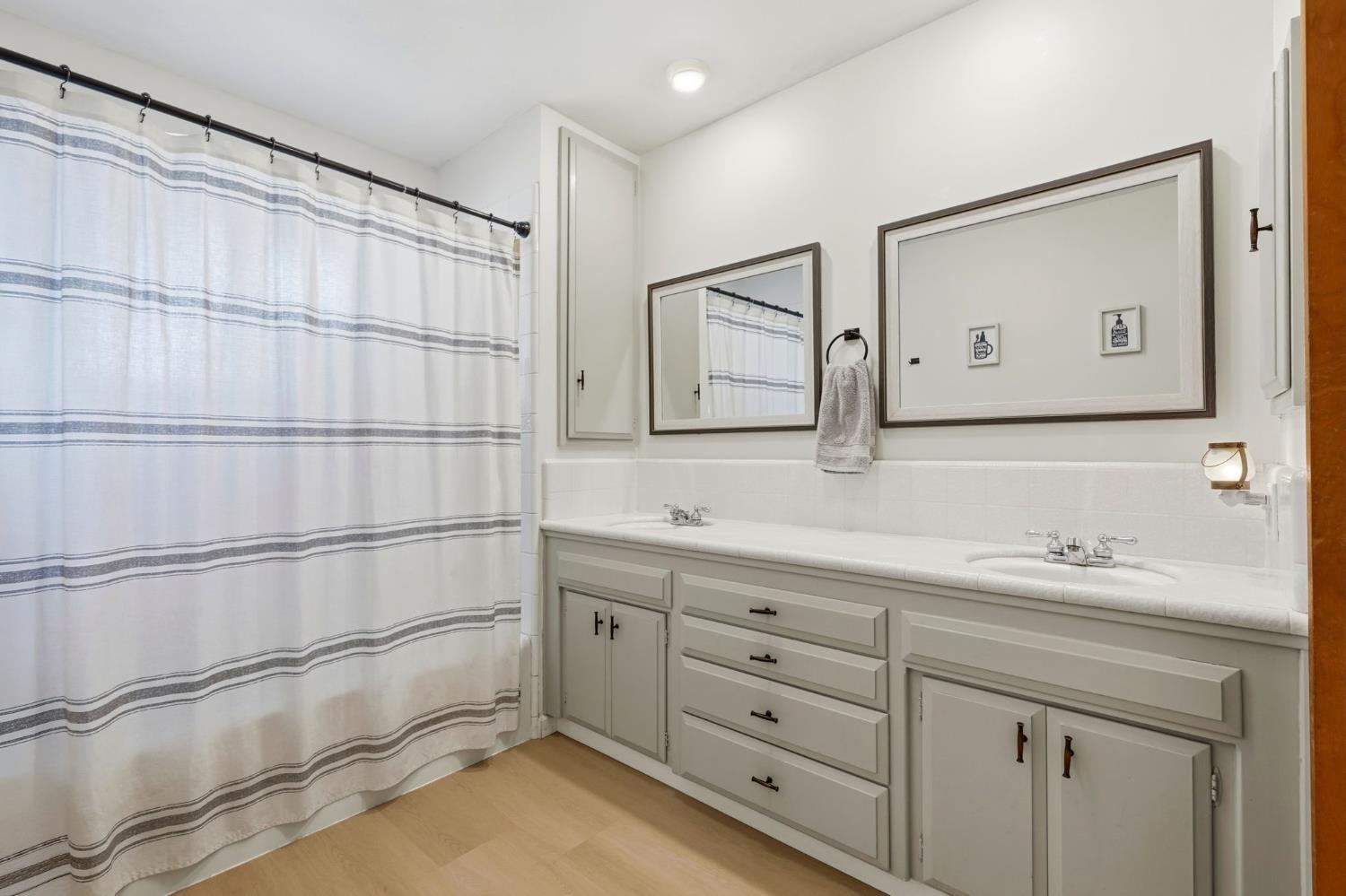 289 West Cypress Avenue Reedley, CA 93654 - Photo 23 of 45 a bathroom with a double vanity sink mirror and