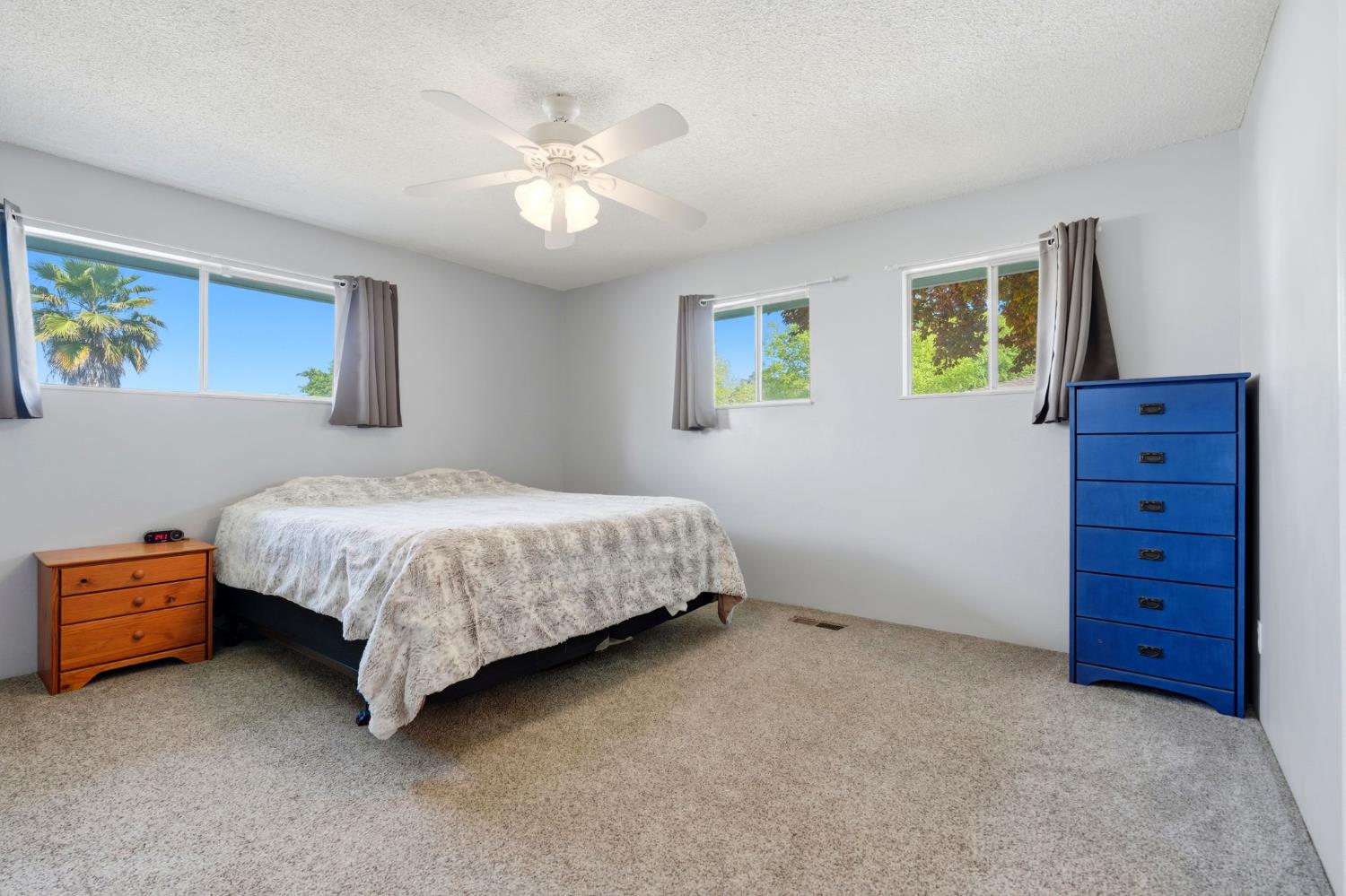 289 West Cypress Avenue Reedley, CA 93654 - Photo 28 of 45 a bedroom with a bed and a chandelier