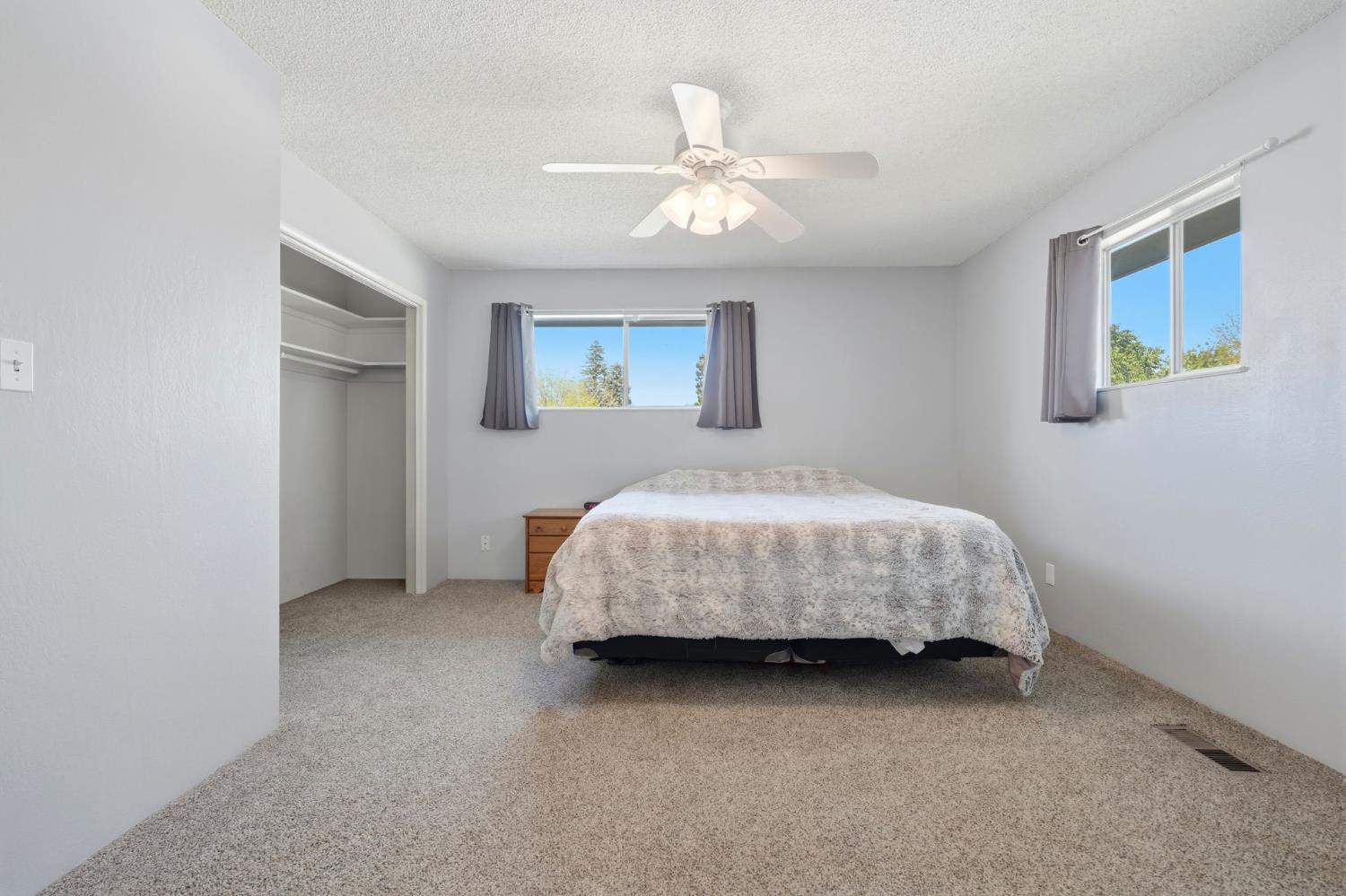 289 West Cypress Avenue Reedley, CA 93654 - Photo 29 of 45 a bedroom with a bed and a chandelier